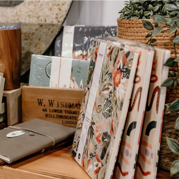 Assorted stack of leather notebooks, floral planners, cute box cards and more! 